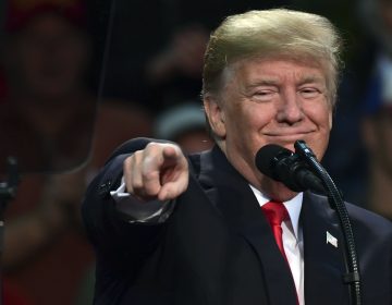 President Trump points out a supporter of Roy Moore, the embattled Alabama Republican Senate candidate, as he speaks at a campaign-style rally in Pensacola, Fla., Friday