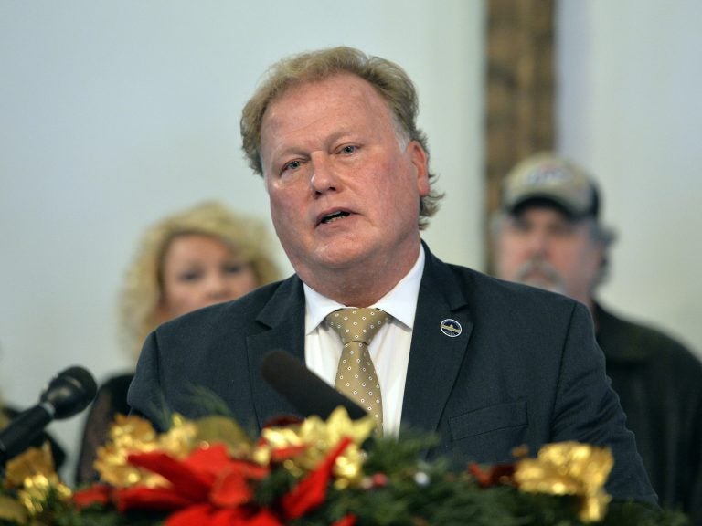 With friends and family standing behind him, Kentucky State Rep., Republican Dan Johnson addresses the public from his church on Tuesday to defend himself against accusations of sexual assaulting a 17-year-old girl in 2012.