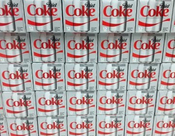 Cases of Diet Coke on display on a grocery store shelf