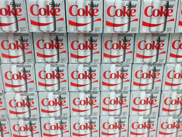 Cases of Diet Coke on display on a grocery store shelf