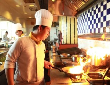 portrait of chef flambe cooking in the kitchen