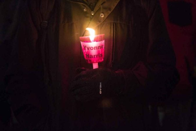 People hold a candle to represent each homeless life lost this year in Philadelphia. (Emily Cohen for WHYY)