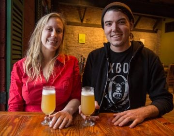 Julie Foster and Jean Broillet IV chat about beer trends at the cafe at their Tired Hands Brewery in Ardmore, Pennsylvania. (Emily Cohen for WHYY)