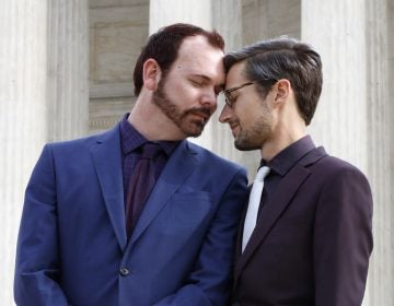Charlie Craig and David Mullins touch foreheads after leaving the Supreme Court