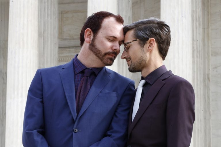 Charlie Craig and David Mullins touch foreheads after leaving the Supreme Court