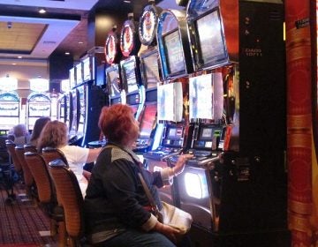 In this June 24, 2016, photo, a gambler plays a slot machine at the Golden Nugget casino in Atlantic City, N.J. On Thursday, Sept. 22, 2016, the men who are proposing to build two new casinos in northern New Jersey near New York City, concluded the statewide ballot question that would authorize the projects will not pass, and ended their financial support for a campaign in its favor. (AP Photo/Wayne Parry)