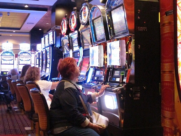 In this June 24, 2016, photo, a gambler plays a slot machine at the Golden Nugget casino in Atlantic City, N.J. On Thursday, Sept. 22, 2016, the men who are proposing to build two new casinos in northern New Jersey near New York City, concluded the statewide ballot question that would authorize the projects will not pass, and ended their financial support for a campaign in its favor. (AP Photo/Wayne Parry)