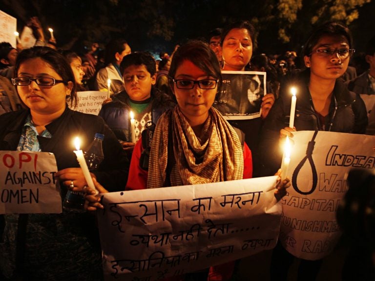Participants in a candlelight vigil in 2013 mark the one-year anniversary of the death of a 23-year-old woman who was gang-raped on a bus in Delhi. (Raj K. Raj/Hindustan Times via Getty Images)