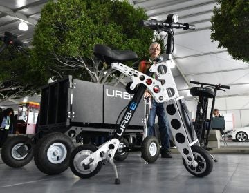 The URB-E electric folding bicycle is displayed Nov. 28 inside the Technology Pavilion at the 2017 LA Auto Show. (Frederic J. Brown/AFP/Getty Images)