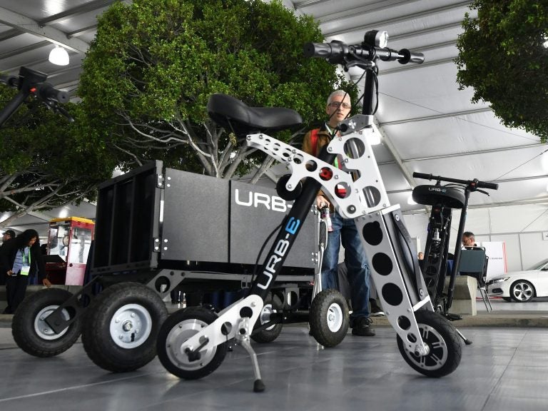 The URB-E electric folding bicycle is displayed Nov. 28 inside the Technology Pavilion at the 2017 LA Auto Show. (Frederic J. Brown/AFP/Getty Images)