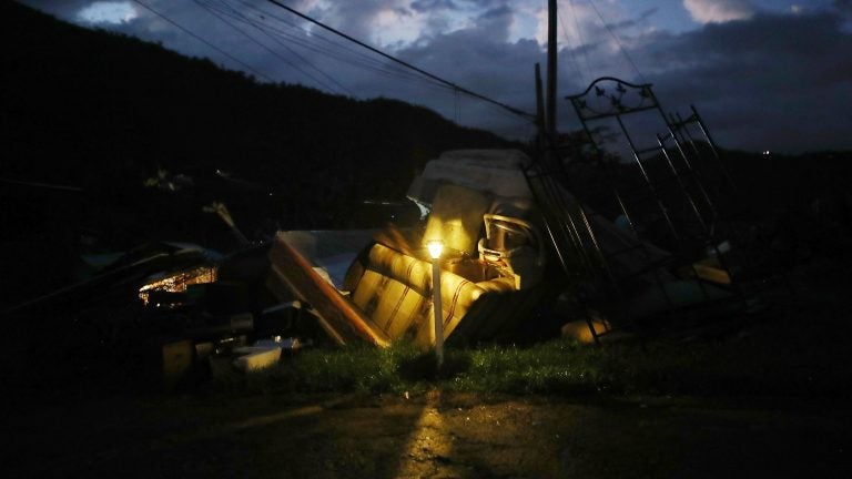 A donated solar lamp in a driveway illuminates storm debris still waiting to be collected earlier this week in Morovis, Puerto Rico. (Mario Tama/Getty Images)