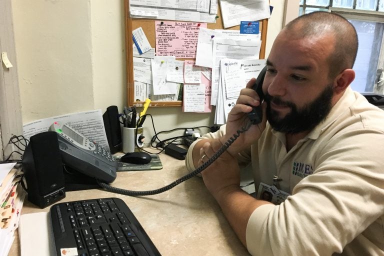 Paul Butler works at the 24-hour hotline at the main psychiatric hospital in Montgomery County, Pennsylvania. (Elana Gordon/WHYY)