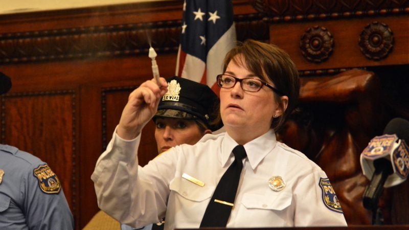 Philadelphia police officer Karen Baldini demonstrates the use of a naloxone nasal spray to revive overdosing heroin users. (Tom MacDonald/WHYY)