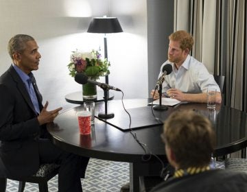 Britain's Prince Harry, right, interviews former U.S. President Barack Obama