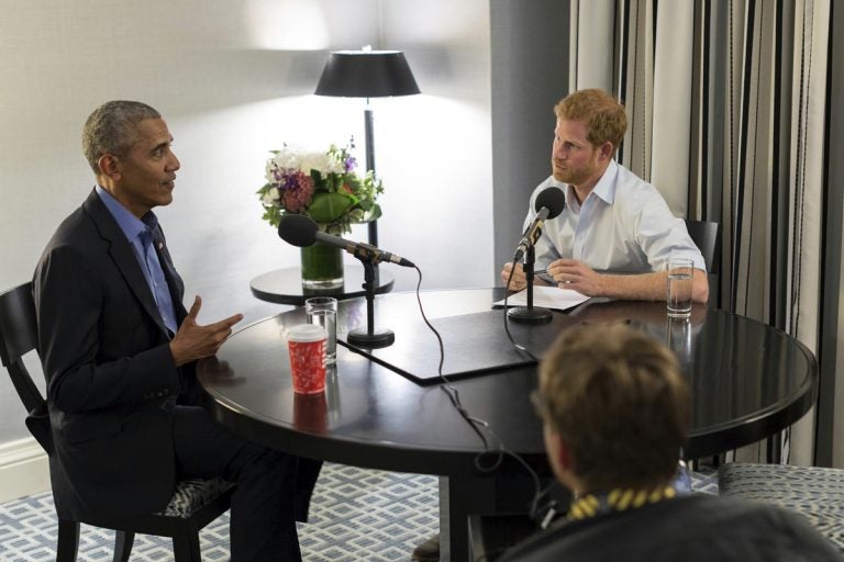 Britain's Prince Harry, right, interviews former U.S. President Barack Obama
