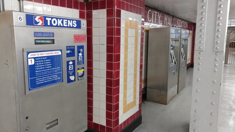A SEPTA token machine (left) will eventually be taken out of service as the electronic Key fare cards, sold at right, gain popularity. (Tom MacDonald/ WHYY)