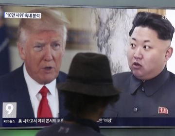 A TV screen shows U.S. President Donald Trump and North Korean leader Kim Jong Un during a news program in Seoul, South Korea.