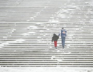 Snow and sleet did not deter two members of the Huerta family, visiting from Houston, from challenging the Rocky Steps. Philadelphia is preparing for up to 3 inches of snow beginning Thursday morning.