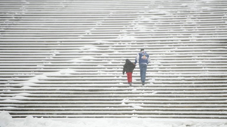 Snow and sleet did not deter two members of the Huerta family, visiting from Houston, from challenging the Rocky Steps. Philadelphia is preparing for up to 3 inches of snow beginning Thursday morning.