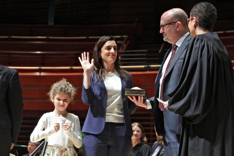 Julia Bright (left) celebrates while her mother, Rebecca Rhynhart (center), is sworn in as Philadelphia city controller.