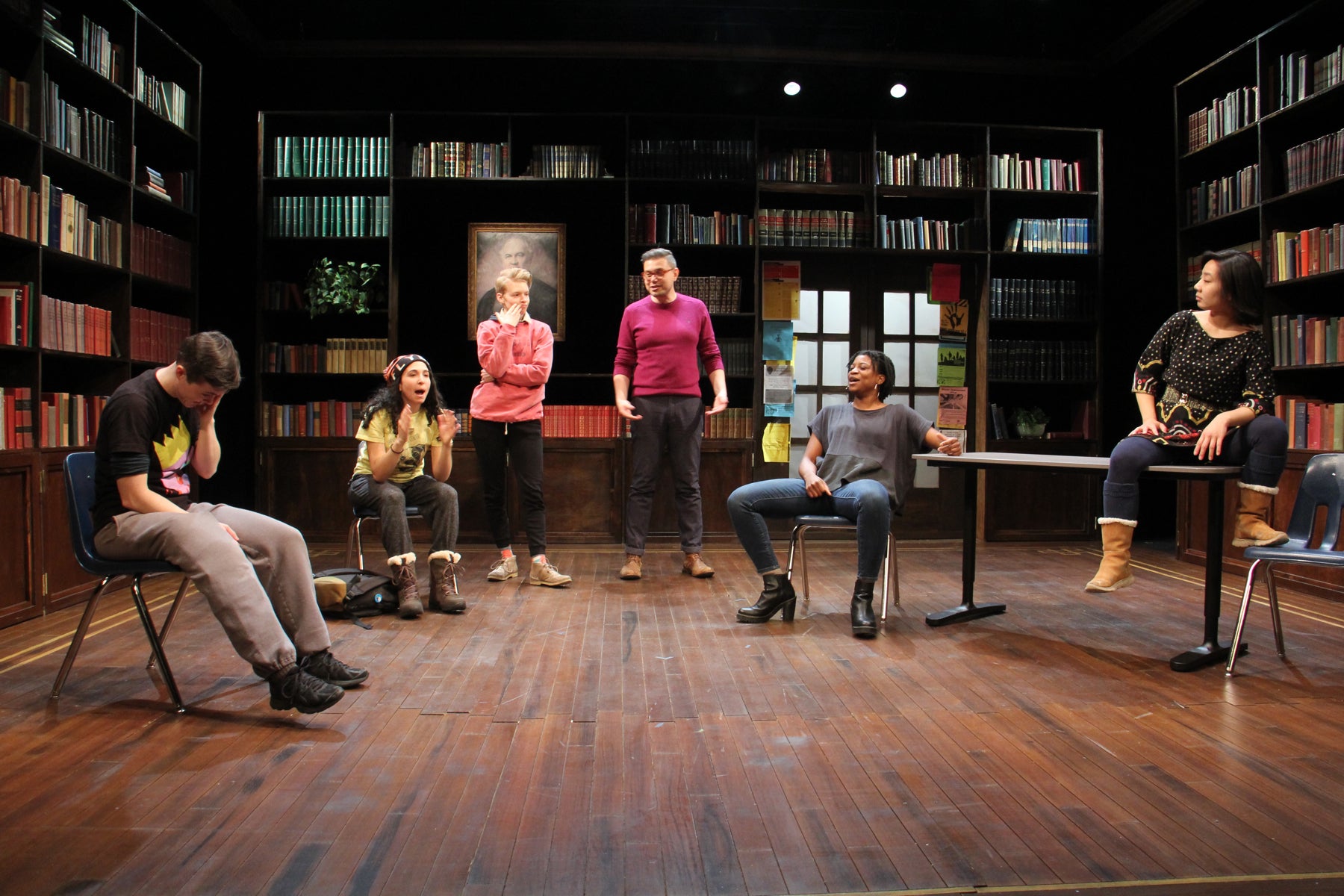 Director Evren Odcikin (center) joins cast members on stage during rehearsal as they take on their male roles. 