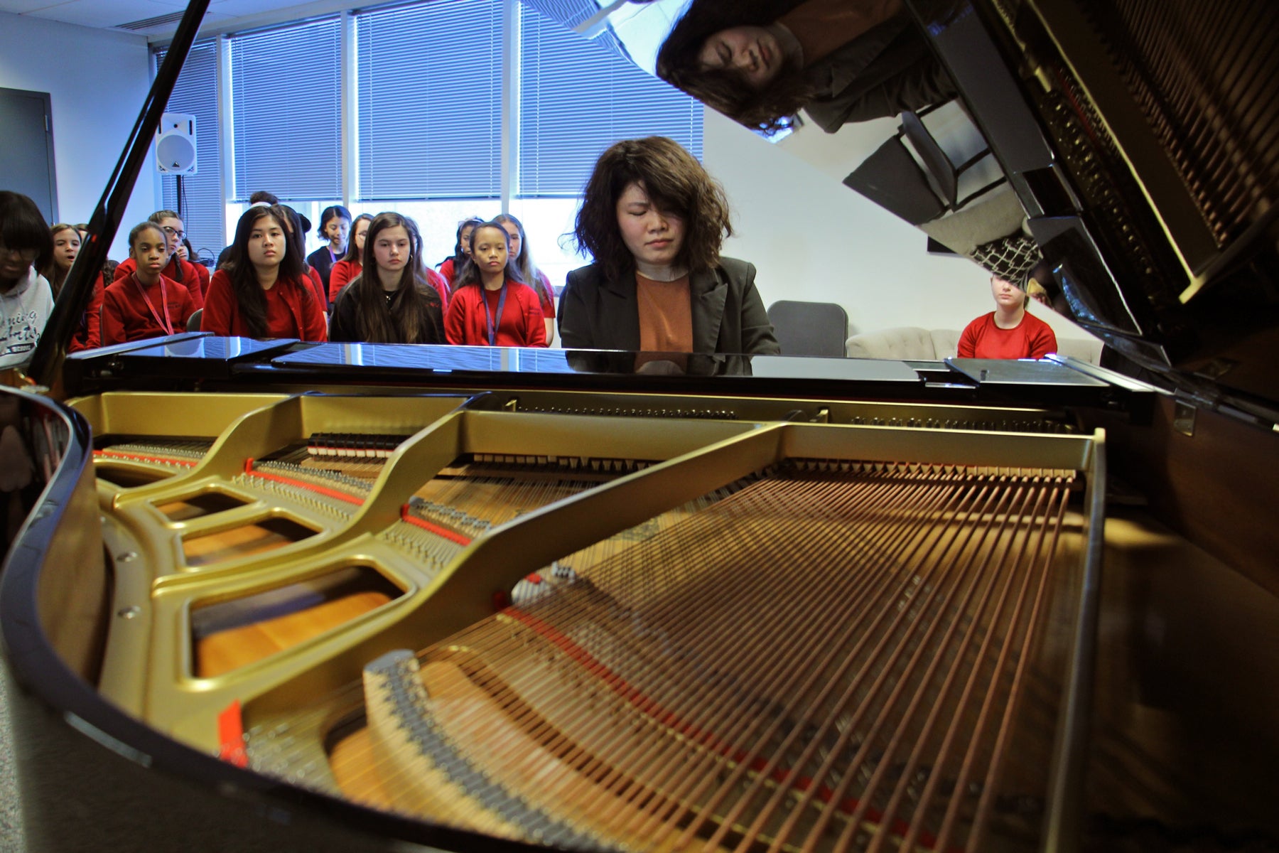 Zhenni Li performs for students after giving an hour-long master class. 