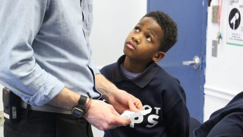 Jahir Ford presents his lyrics for approval before recording his rap. (Emma Lee/WHYY)