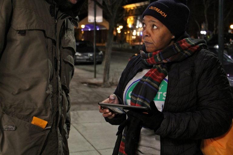 Monique Taylor interviews a homeless man near Headhouse Square for the 2018 homeless census. Like many of the volunteers who fanned out across the city Wednesday night, Taylor has experienced homelessness.