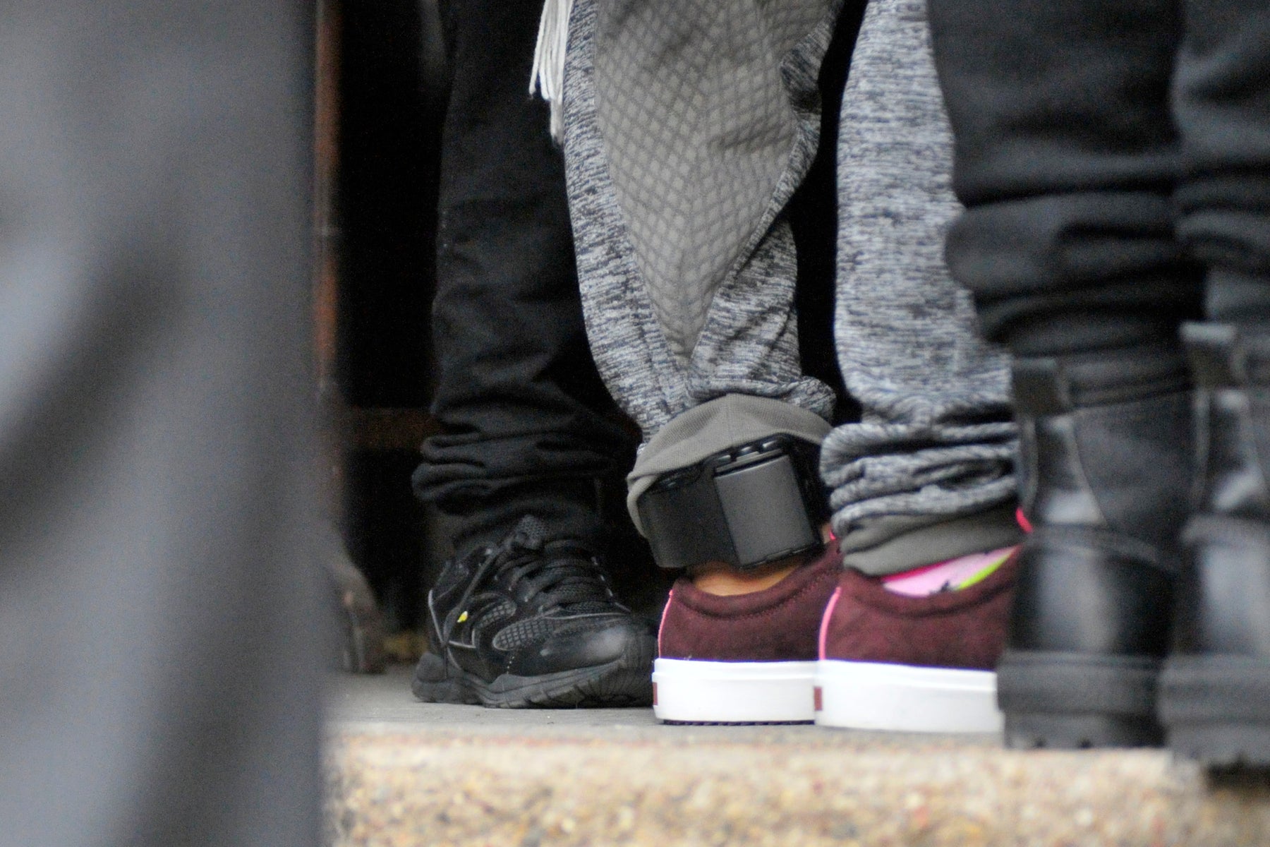 The ankle monitor worn by Camela Apolonio Hernandez is visible as she sees her children off in the doorway of her sanctuary at Church of the Advocate in North Philadelphia.