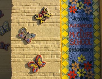 A five-year mural project covers the facade of the McClure School in North Philadelphia with colorful mosaics designed by students.