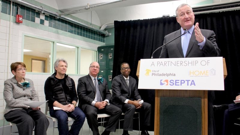 Philadelphia Mayor Jim Kenney speaks at the ribbon cutting for Hub of Hope. Seated (from left) are Sister Mary Scullion of Project HOME, rocker philanthropist Jon Bon Jovi, SEPTA Board Chairman Pasquale T. Deon Sr., and City Council President Darrell Clarke. (Emma Lee/WHYY)