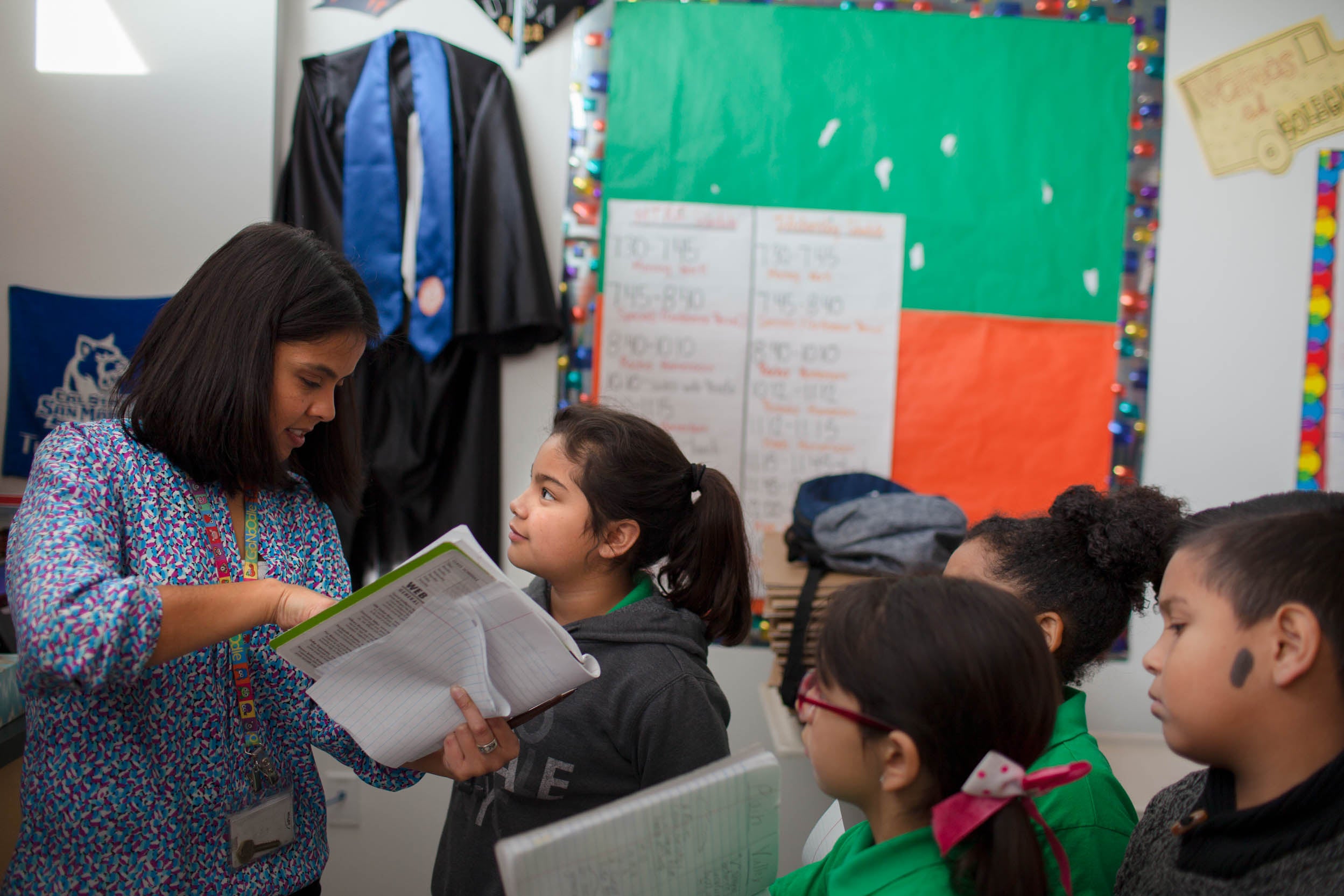 Rocha checks her student's work during her third-grade science class.