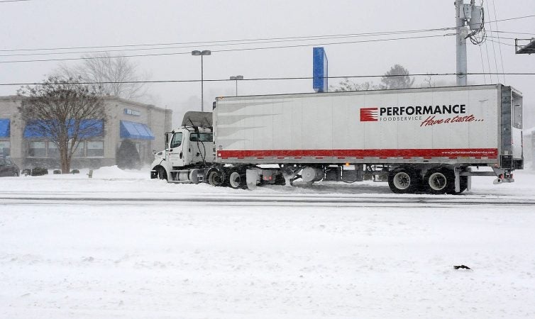 Trucks like this and lots of cars struggled to get out of drifting snow after sliding on the roads near the Delaware beaches.  (Chuck Snyder/for WHYY)
