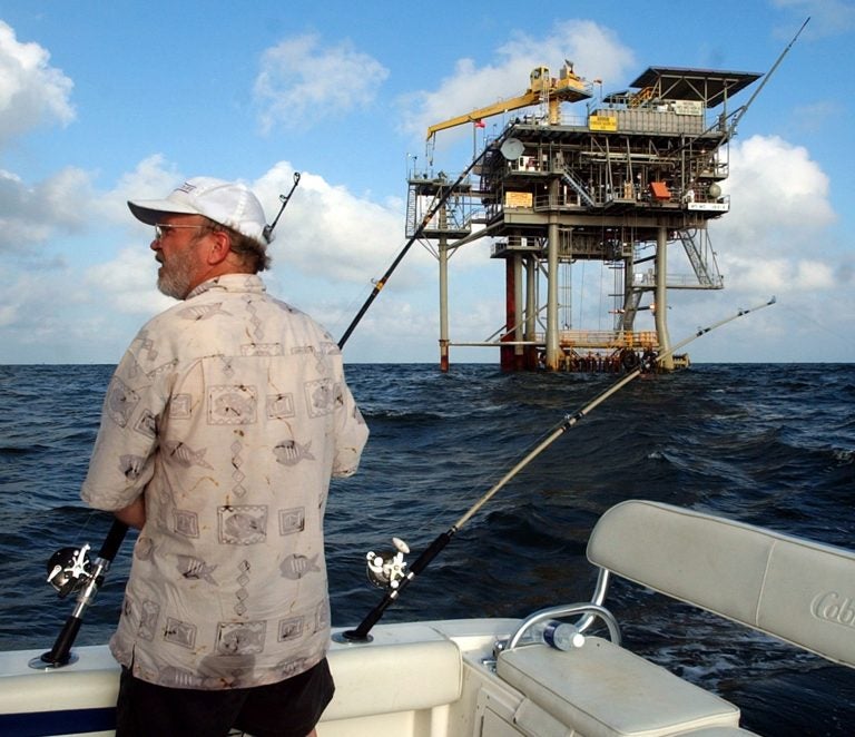 FILE - In this Friday, May 9, 2003 file photo, angler Andy Hails, of Montgomery, Ala., checks the fishing lines on his boat as he trolls the Gulf of Mexico near a natural gas well off the Alabama coast near Gulf Shores, Ala. President Obama announced his new offshore drilling policy Wednesday, March 31, 2010. (AP Photo/Dave Martin, File)