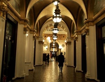 A man walks down a hall toward the light of the Capitol rotunda, Wednesday, March 15, 2006, in Harrisburg, Pa.