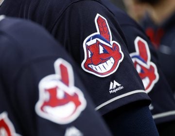 Members of the Cleveland Indians wear uniforms featuring mascot Chief Wahoo as they stand on the field for the national anthem before a baseball game against the Baltimore Orioles in Baltimore, Monday, June 19, 2017.