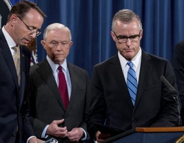 FBI Acting Director Andrew McCabe, right, accompanied by Attorney General Jeff Sessions, second from left, Deputy Attorney General Rod Rosenstein, takes the podium at a news conference to announce an international cybercrime enforcement action at the Department of Justice, Thursday, July 20, 2017, in Washington.