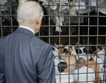 U.S. Attorney General Jeff Sessions stops to look at cell conditions during a tour of a police station and detention center in San Salvador, El Salvador, in July. The city is known as one of the most dangerous in the world. The Trump administration is expected to decide Monday whether to extend temporary protected status to 250,000 Salvadorans in the U.S. (