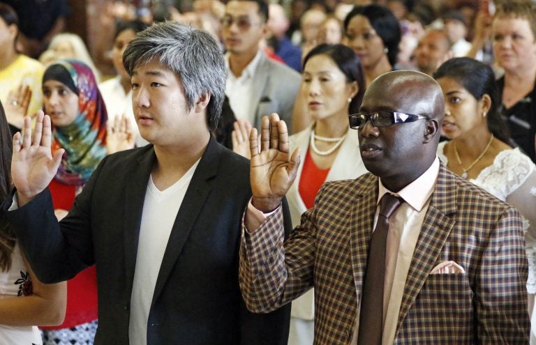 Immigrants from 23 countries recite the Oath of Allegiance during the naturalization ceremony