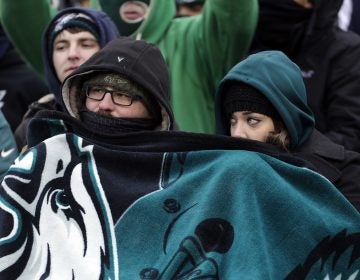 Philadelphia Eagles' fans huddle during the second half of an NFL football game against the Dallas Cowboys, Sunday, Dec. 31, 2017, in Philadelphia.