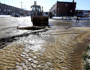 Mud and ice are cleared from the road during cleanup after a water main break last week in Northeast Philadelphia. City workers are dealing with about 20 water main breaks a day, officials say.