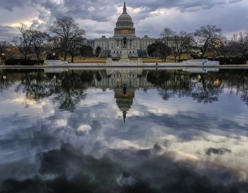 Clouds are reflected in the U.S. Capitol reflecting pool at daybreak in Washington D.C.