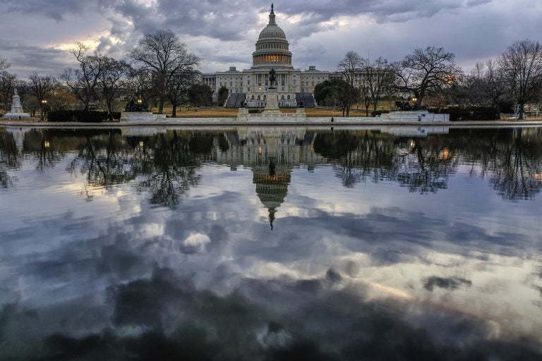 Clouds are reflected in the U.S. Capitol reflecting pool at daybreak in Washington D.C.