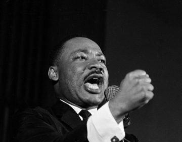 Dr. Martin Luther King Jr. shakes his fist during a speech in Selma, Ala., Feb. 12, 1965. King was engaged in a battle with Sheriff Jim Clark over voting rights and voter registration in Selma. (AP Photo/Horace Cort)
