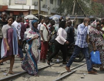 Pedestrian cross a rail line in Lagos, Nigeria, Friday, Jan. 12, 2018. Africans were shocked on Friday to find President Donald Trump had finally taken an interest in their continent. But it wasn't what people had hoped for. Using vulgar language, Trump on Thursday questioned why the U.S. would accept more immigrants from Haiti and 