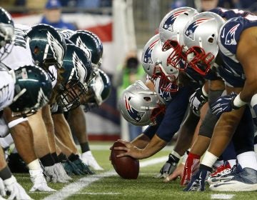 In this Dec. 6, 2015, file photo, the New England Patriots and the Philadelphia Eagles get set for the snap at the line of scrimmage during an NFL football game at Gillette Stadium in Foxborough, Mass. (Winslow Townson/AP Images for Panini via AP, File)