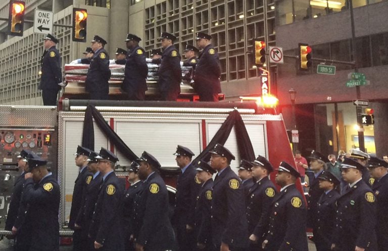 Firefighters line up as the body of Philadelphia firefighter Lt. Matthew LeTourneau is carried on top of a firetruck during a funeral procession on Friday, Jan. 12, 2018 in Philadelphia. Officials say the funeral mass for Lt. Matthew LeTourneau will be held Friday at the Cathedral Basilica of Saints Peter and Paul in Philadelphia. The 11-year veteran was pulled from the home on Saturday by fellow firefighters and taken to a hospital, where he was later pronounced dead.