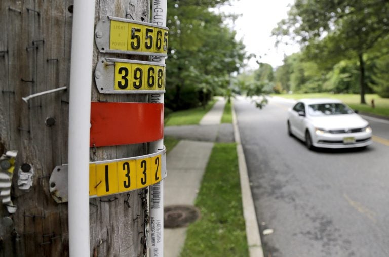 In this Aug. 5, 2017, file photo, a vehicle drives past polyvinyl chloride piping attached to a utility pole, signifying an outdoor area known as an eruv where Jewish residents observing certain restrictions during the Sabbath are permitted to carry items from home, along Airmount Road in Mahwah, N.J. The New Jersey state attorney general's office issued a subpoena to Mahwah township in August 2017 after the township adopted a rule limiting a public park to state residents, which opponents say targets the Jewish community from a nearby New York town. (Julio Cortez/AP Photo, File)