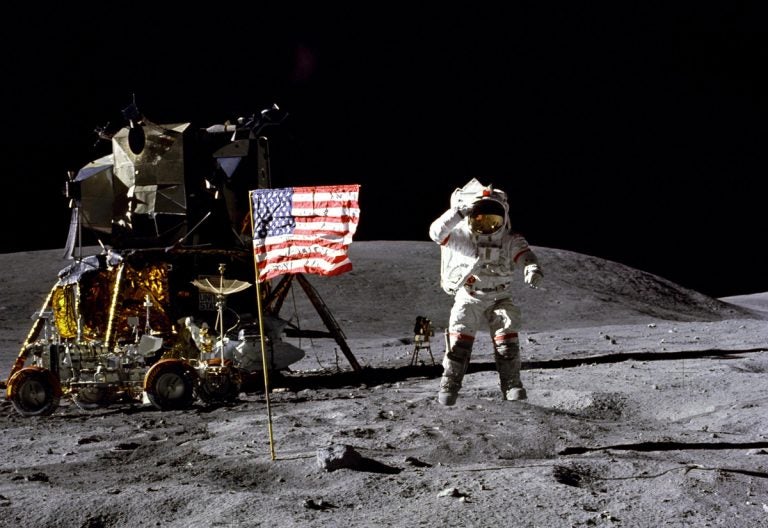 In this April 1972 photo made available by NASA, John Young salutes the U.S. flag at the Descartes landing site on the moon during the first Apollo 16 extravehicular activity. NASA says the astronaut, who walked on the moon and later commanded the first space shuttle flight, died on Friday, Jan. 5, 2018. He was 87. (Charles M. Duke Jr./NASA via AP)