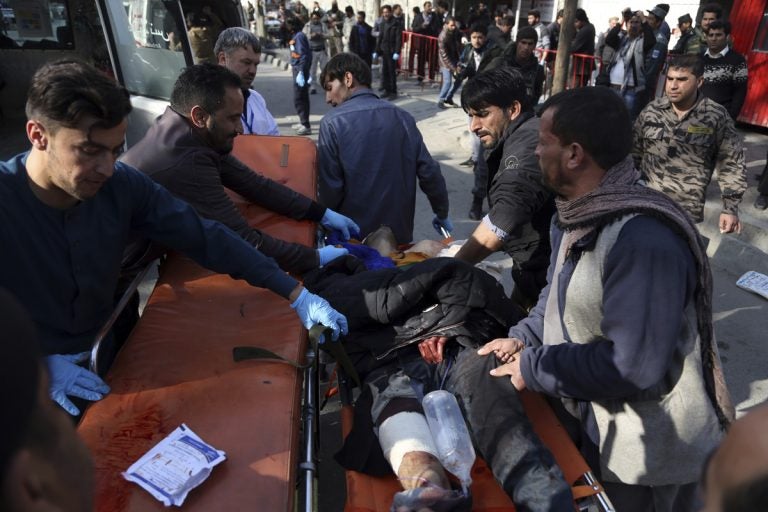 An injured man is moved to a stretcher outside a hospital following a suicide attack in Kabul, Afghanistan, Saturday Jan. 27, 2018. A suicide car bomber killed at least 40 people and wounded about 140 more in an attack claimed by the Taliban on Saturday in Afghanistan's capital Kabul, authorities said. (Rahmat Gul/AP Photo)